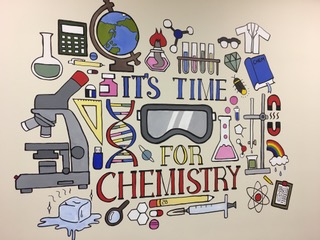 Wall with art that reads 'It's Time For Chemistry'