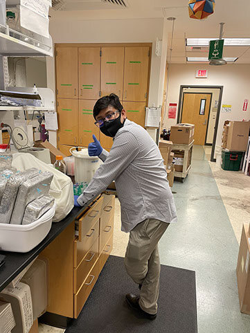 Dr. Samdin right back to research soon after having his PhD celebratory cake. Congratulations Dr. Samdin!